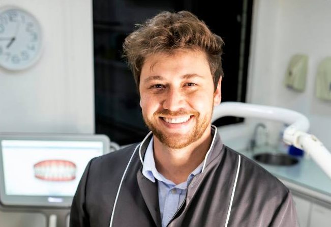 A smiling dentist in a dental clinic