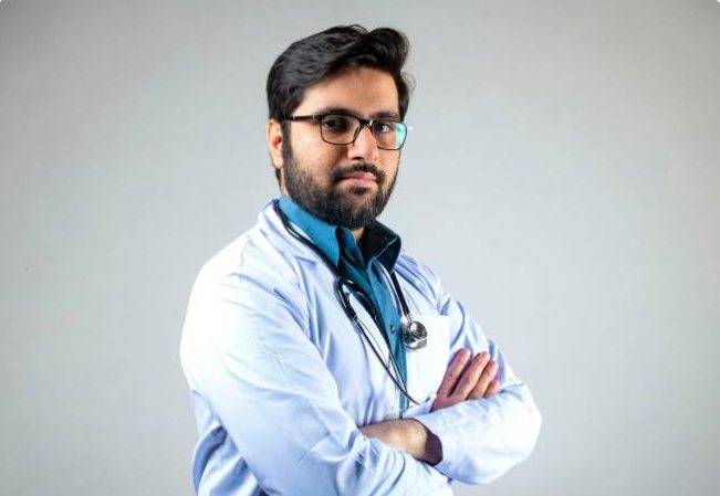 A physician in a white coat with a stethoscope